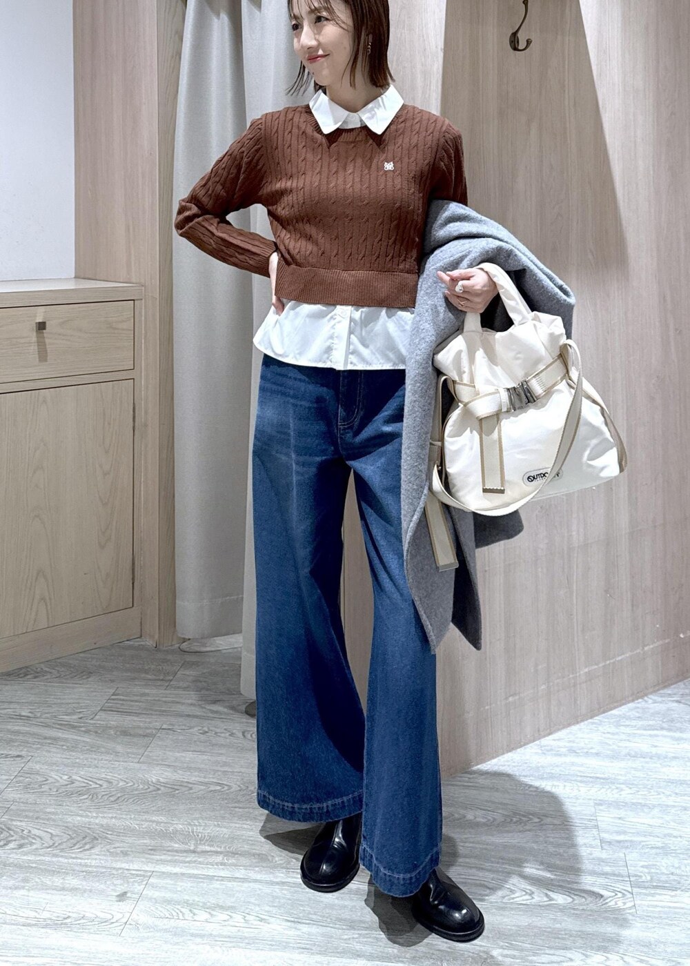 グレー系のその他アウター、ブラウン系のニット/セーター、ブルー系のデニムパンツを着用したレディースの冬コーディネートの5枚目の写真