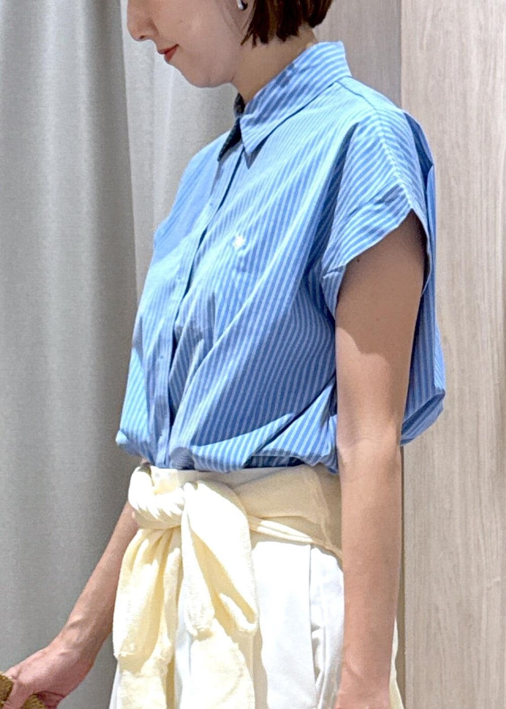 ブラック系のサンダル、ホワイト系のカーディガン/ボレロ、ブルー系のシャツ/ブラウスを着用したレディースの夏コーディネートの6枚目の写真