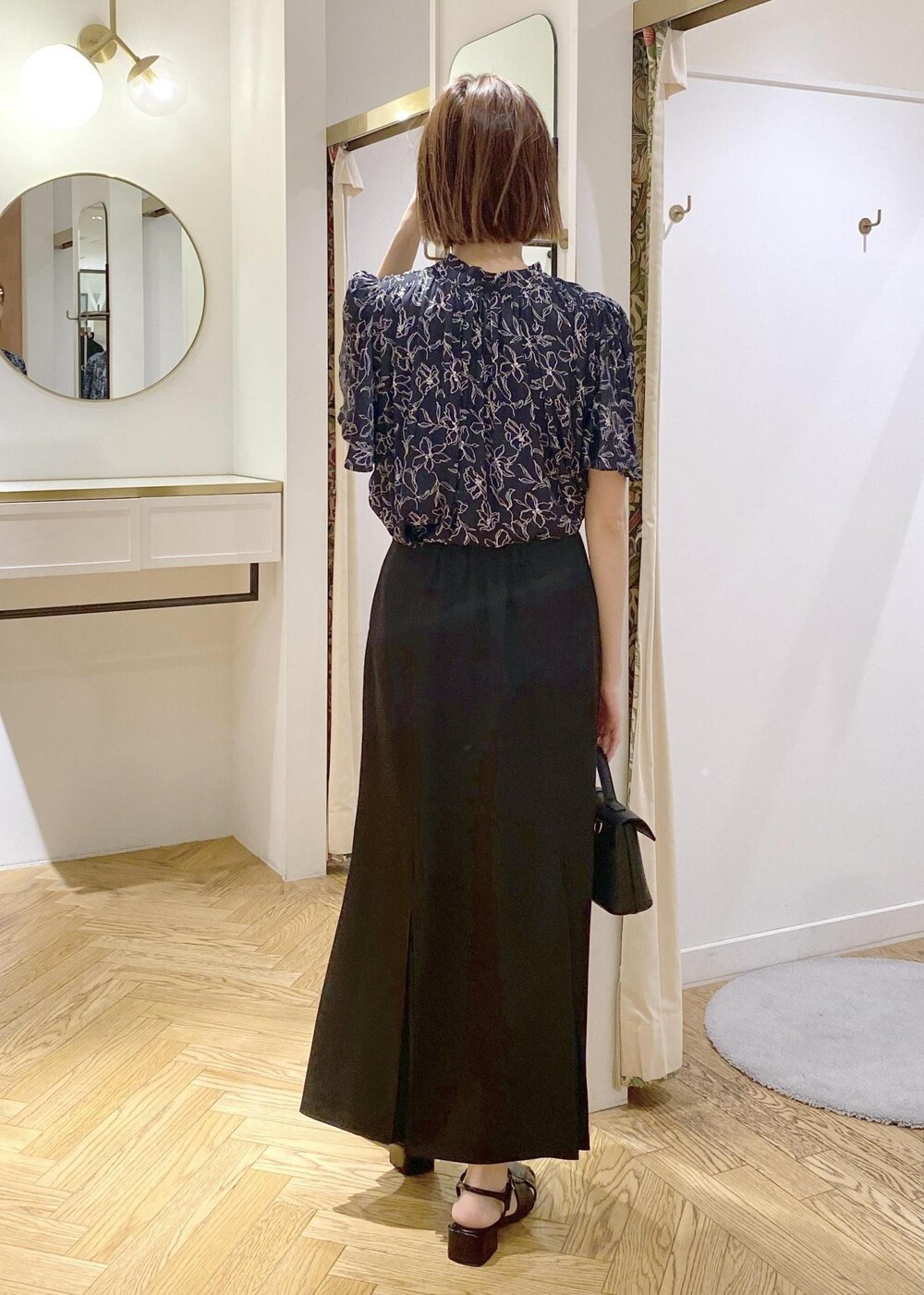 ブラック系のキャミソール、ブラック系のサンダル、ブラック系のスカートを着用したレディースの春コーディネートの4枚目の写真