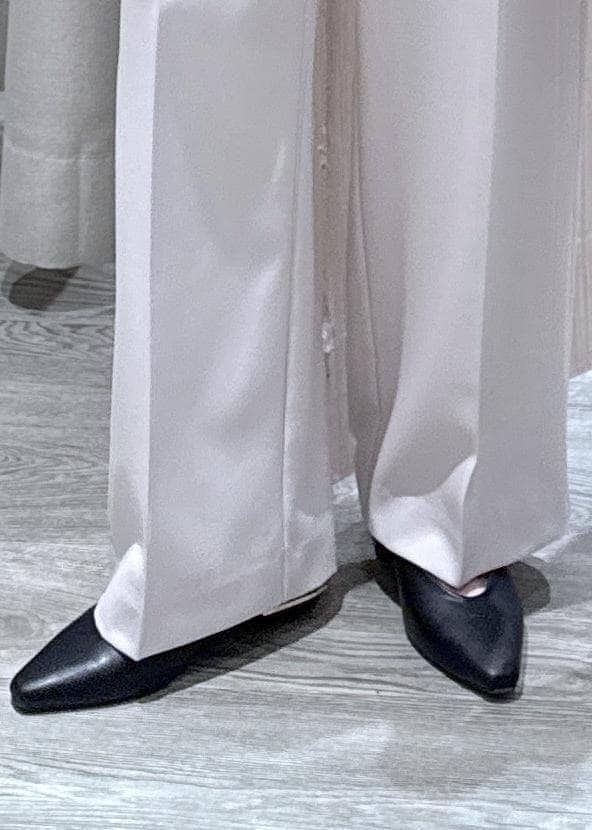 ベージュ系のその他パンツ、ホワイト系のカーディガン/ボレロ、ブラック系のショルダーバッグを着用したレディースの春コーディネートの9枚目の写真