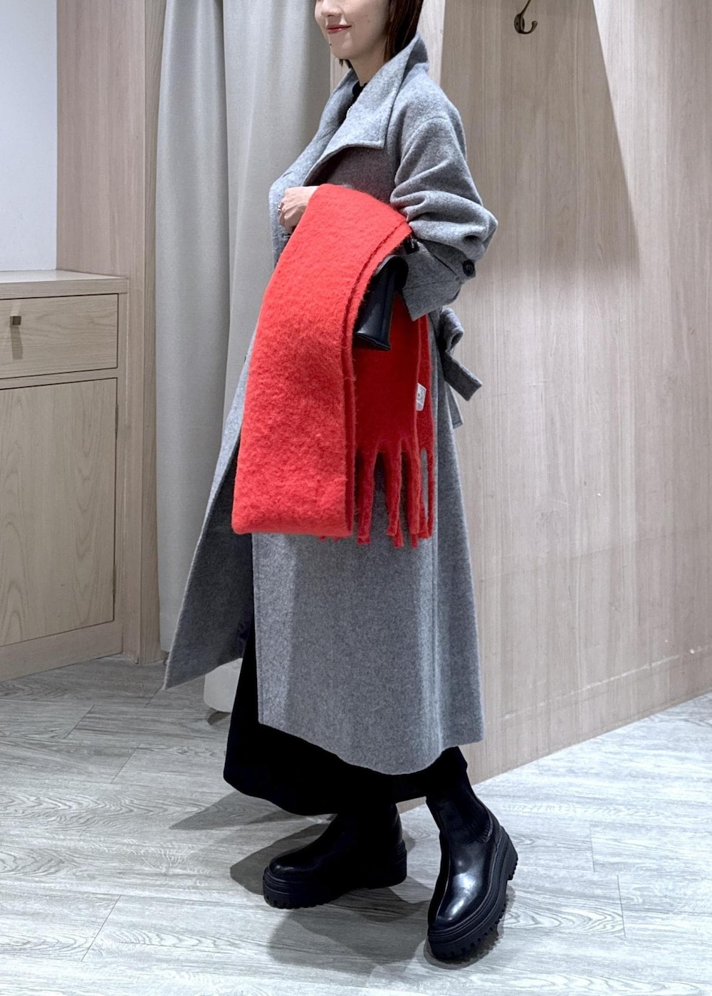 ブラック系のショルダーバッグ、ブラック系のブーツ、ブラック系のワンピースを着用したレディースの冬コーディネートの10枚目の写真