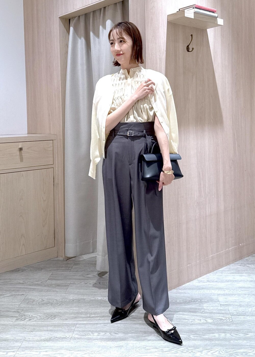 ブラック系のショルダーバッグ、ブラック系のパンプス、ホワイト系のカーディガン/ボレロを着用したレディースの春コーディネートの10枚目の写真