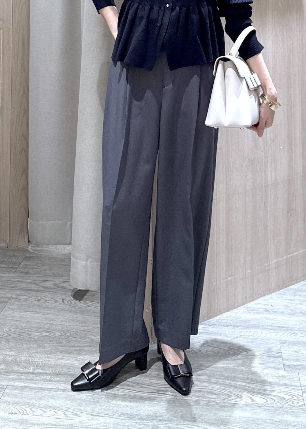 ブラック系のパンプス、グレー系のその他パンツ、ブルー系のカーディガン/ボレロを着用したレディースの冬コーディネートの8枚目の写真