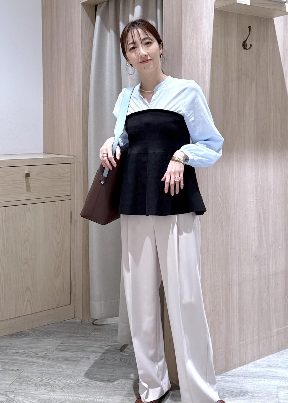 ブラウン系のトートバッグ、ベージュ系のその他パンツ、ブラック系のシャツ/ブラウスを着用したレディースの春コーディネートの9枚目の写真