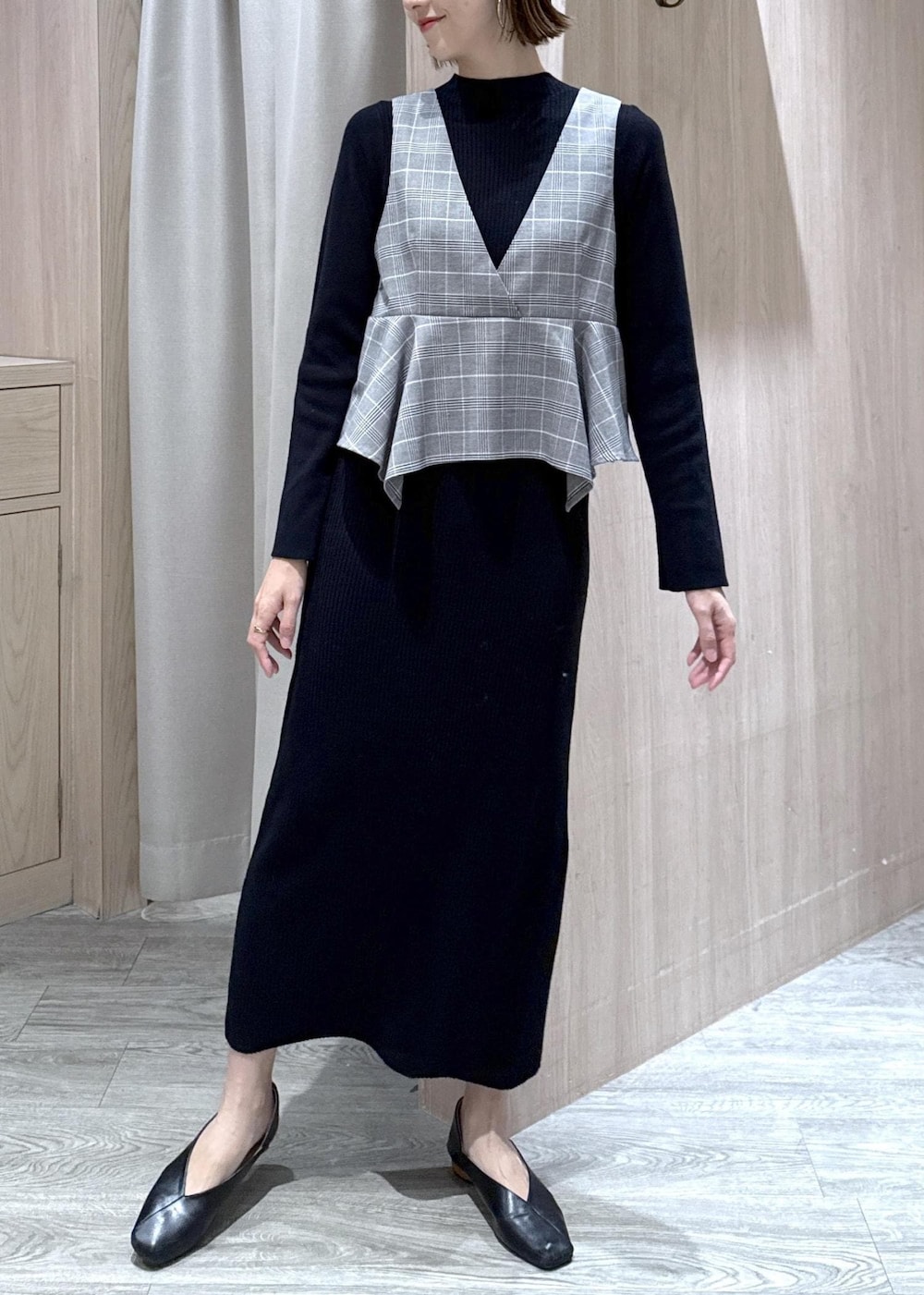 グレー系のテーラードジャケット、ブラック系のショルダーバッグ、ブラック系のワンピースを着用したレディースの冬コーディネートの5枚目の写真