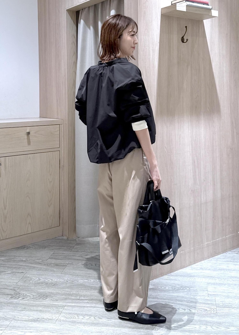 ブラック系のパンプス、ブラック系のトートバッグ、ベージュ系のその他パンツを着用したレディースの冬コーディネートの3枚目の写真