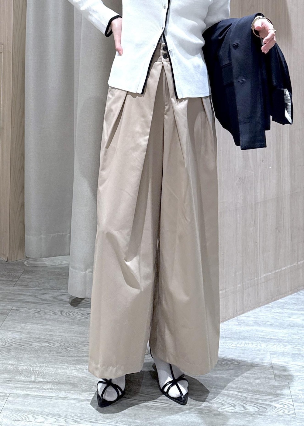 ブルー系のテーラードジャケット、ブラック系のトートバッグ、ホワイト系のカーディガン/ボレロを着用したレディースの冬コーディネートの9枚目の写真