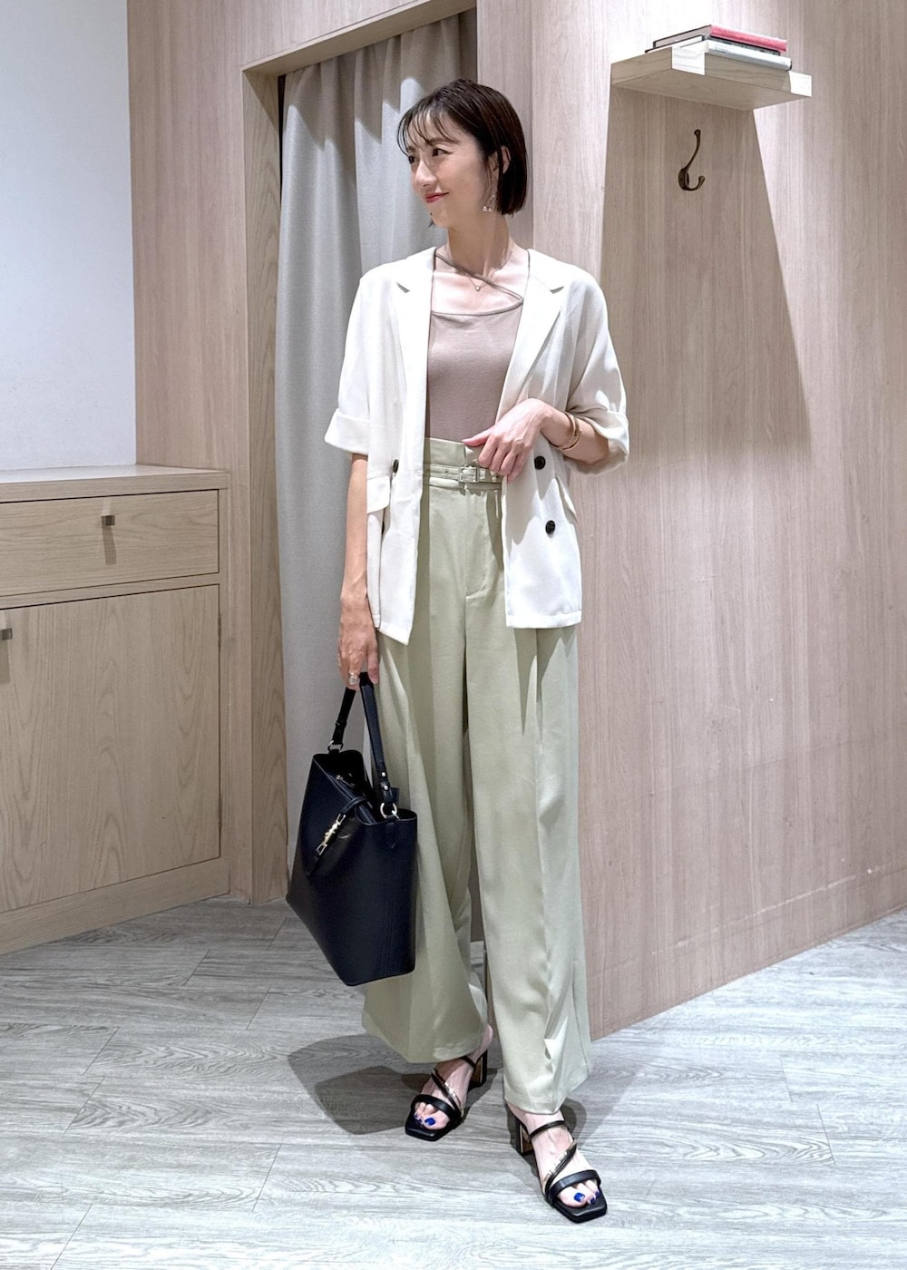 ベージュ系のキャミソール、ブラック系のサンダル、ブラック系のトートバッグを着用したレディースの夏コーディネートの2枚目の写真