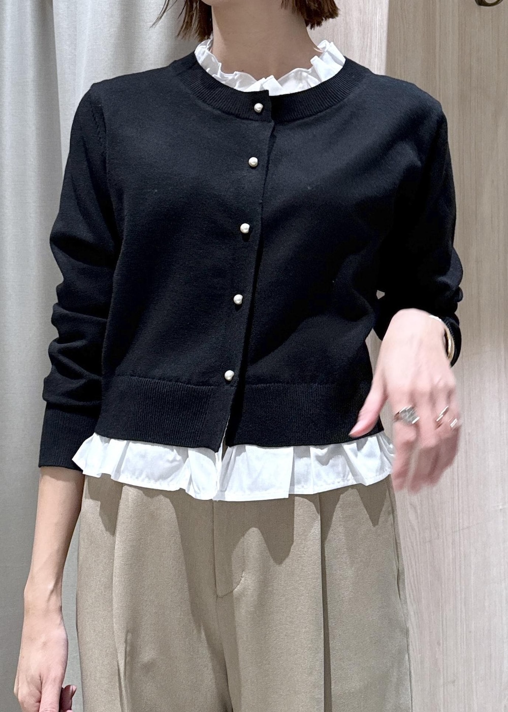 ブラック系のショルダーバッグ、ベージュ系のスラックス、ブラック系のテーラードジャケットを着用したレディースの冬コーディネートの6枚目の写真