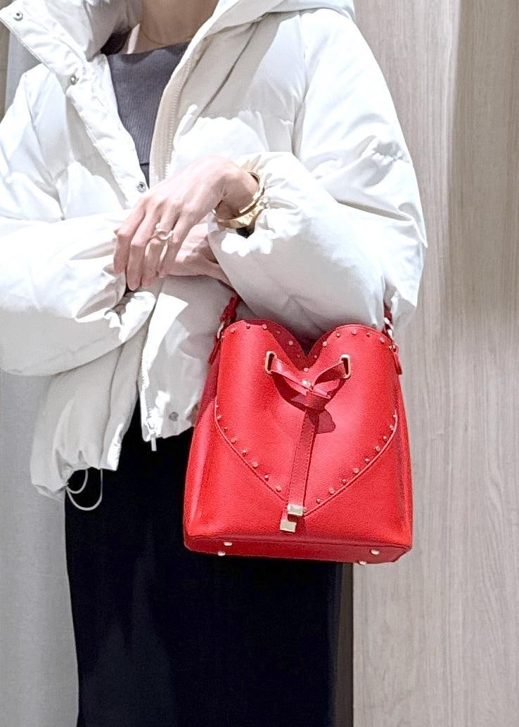 ブラック系のスカート、ブラック系のブーツ、グレー系のニット/セーターを着用したレディースの冬コーディネートの6枚目の写真