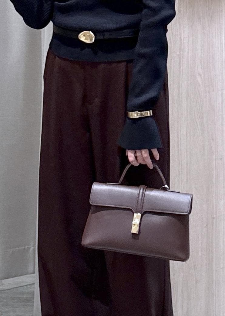 ブラウン系のその他パンツ、ブラウン系のショルダーバッグ、ブラック系のニット/セーターを着用したレディースの秋コーディネートの7枚目の写真