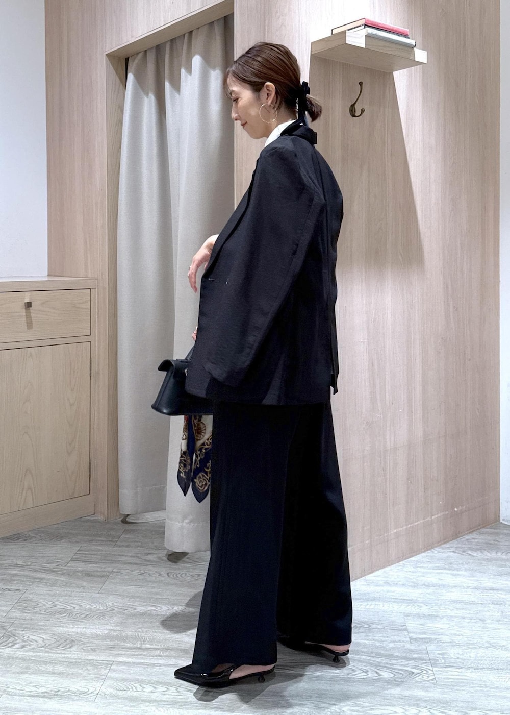 ブラック系のショルダーバッグ、ブラック系のパンプス、ブラック系のテーラードジャケットを着用したレディースの夏コーディネートの2枚目の写真