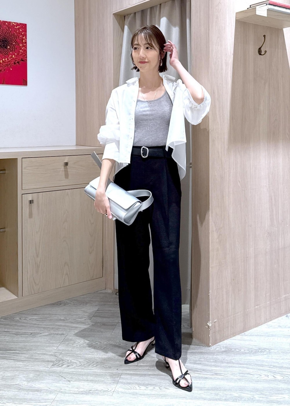 グレー系のタンクトップ、シルバー系のショルダーバッグ、ブラック系のサンダルを着用したレディースの春コーディネートの2枚目の写真