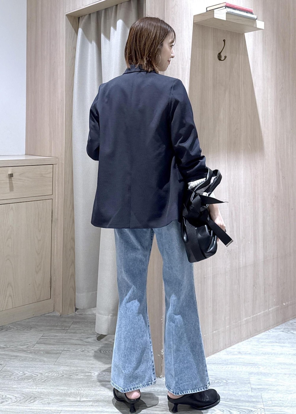 ホワイト系のニット/セーター、ブルー系のテーラードジャケット、ブルー系のデニムパンツを着用したレディースの冬コーディネートの3枚目の写真