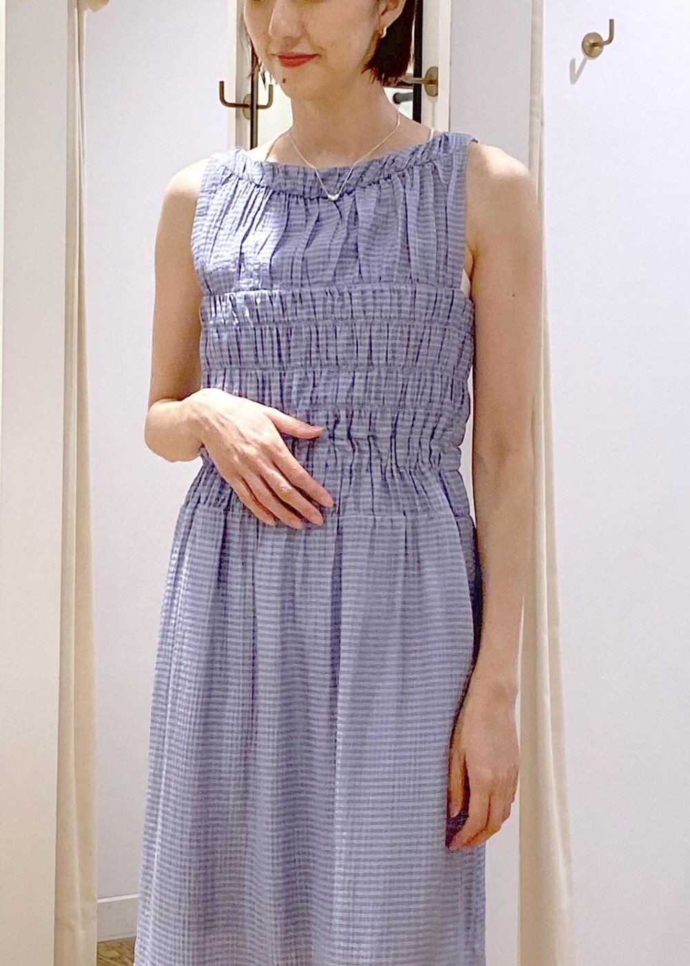 ホワイト系のサンダル、ブルー系のワンピース、シルバー系のショルダーバッグを着用したレディースの夏コーディネートの7枚目の写真