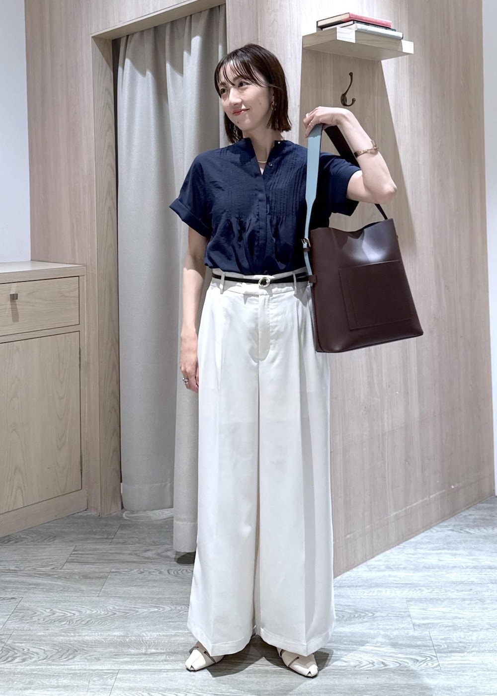 ブラウン系のトートバッグ、ホワイト系のパンプス、ブルー系のシャツ/ブラウスを着用したレディースの夏コーディネートの10枚目の写真