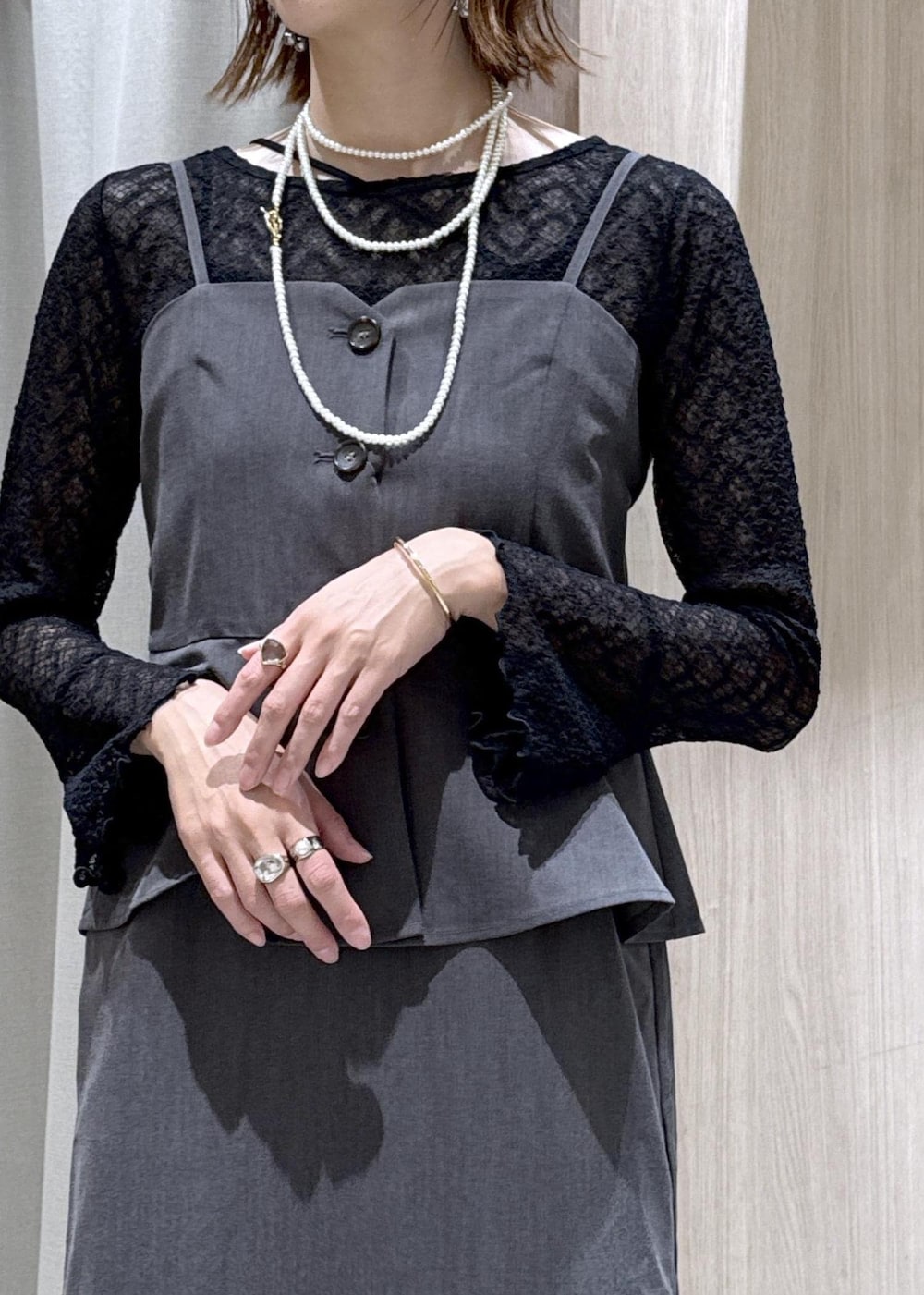 ブラック系のハンドバッグ、ブラック系のキャミソール、ブラック系のパンプスを着用したレディースの秋コーディネートの7枚目の写真