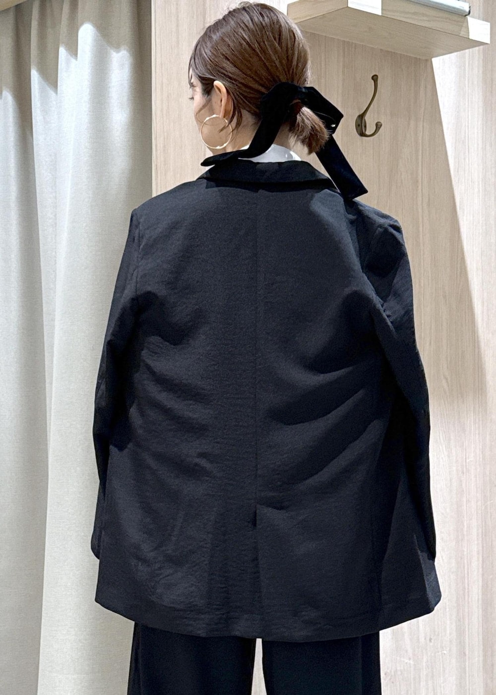 ブラック系のショルダーバッグ、ブラック系のパンプス、ブラック系のテーラードジャケットを着用したレディースの夏コーディネートの8枚目の写真