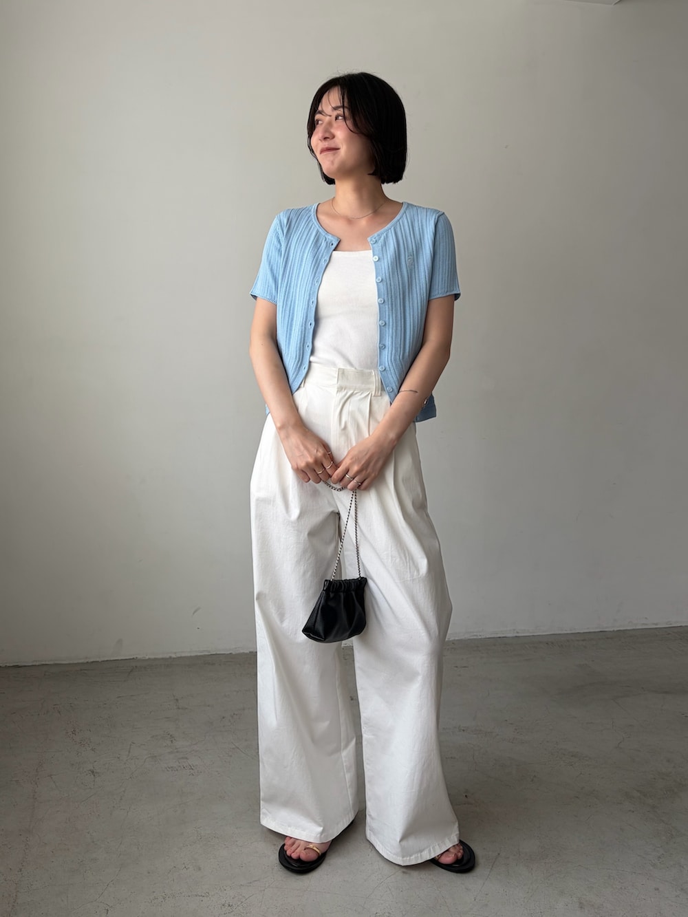 ホワイト系のその他パンツ、ホワイト系のキャミソール、ブルー系のカーディガン/ボレロを着用したレディースの夏コーディネートの2枚目の写真