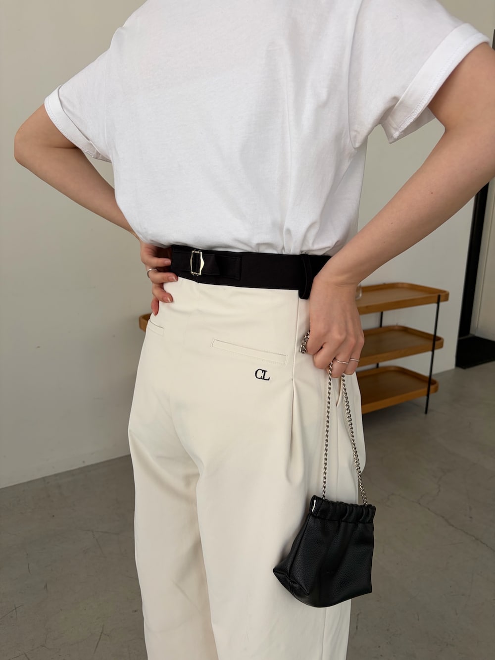 ホワイト系のその他パンツ、ホワイト系のTシャツ/カットソー、ブラック系のショルダーバッグを着用したレディースの冬コーディネートの3枚目の写真