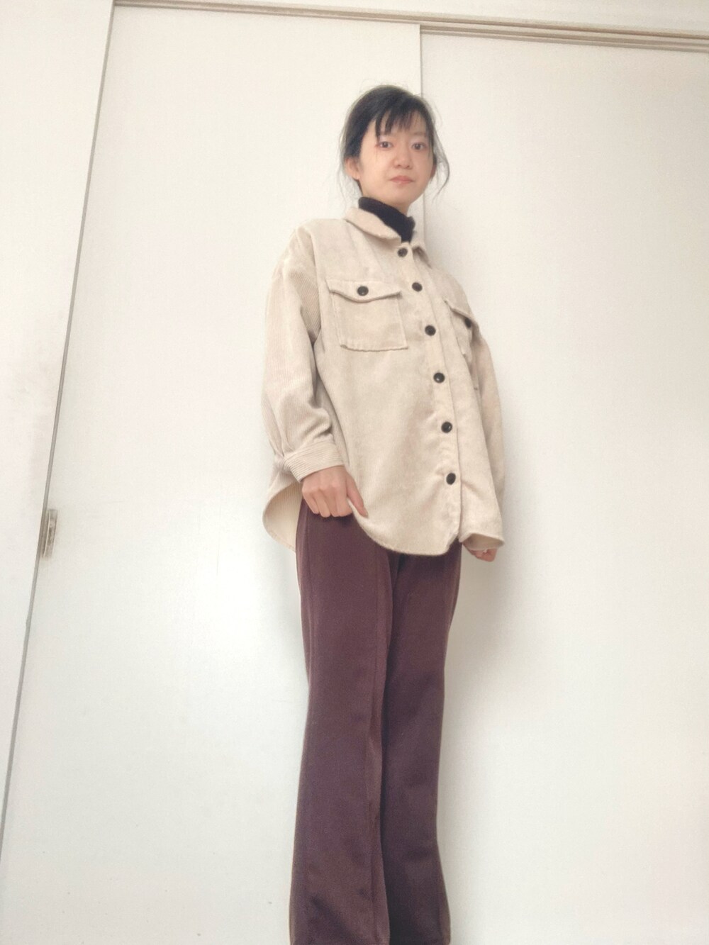 ブラウン系のパンツを着用したレディースの冬コーディネートの2枚目の写真