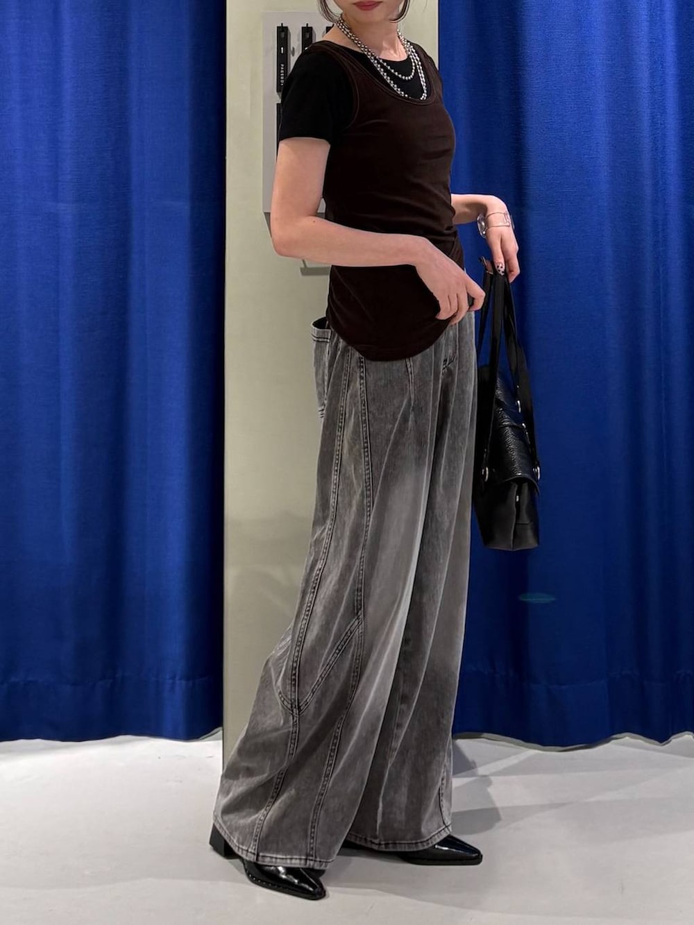 ブラウン系のタンクトップ、ブラック系のデニムパンツ、ブラック系のTシャツ/カットソーを着用したレディースの夏コーディネートの2枚目の写真