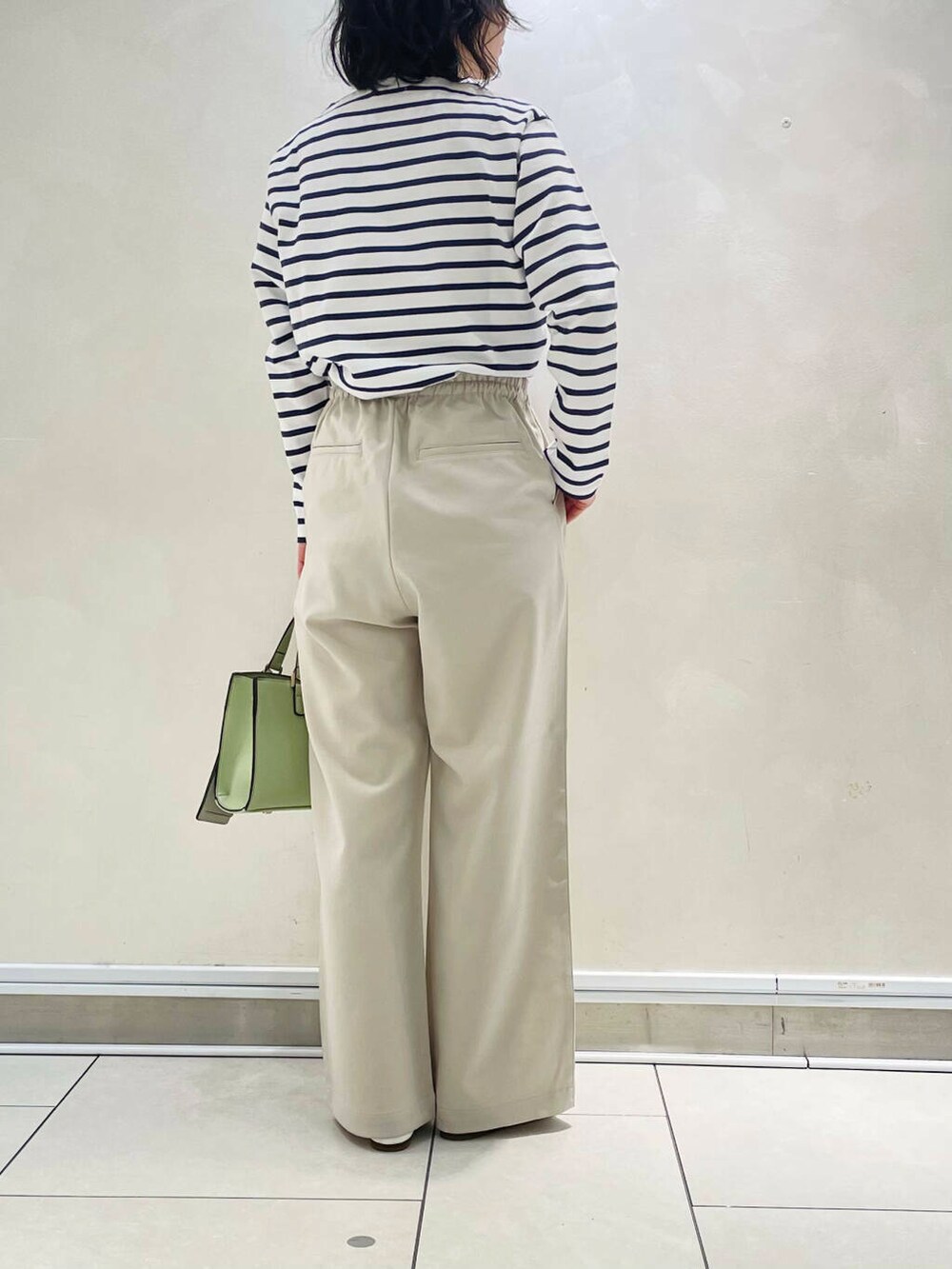 ホワイト系のパンプス、ベージュ系のその他パンツ、ブルー系のTシャツ/カットソーを着用したレディースの冬コーディネートの5枚目の写真