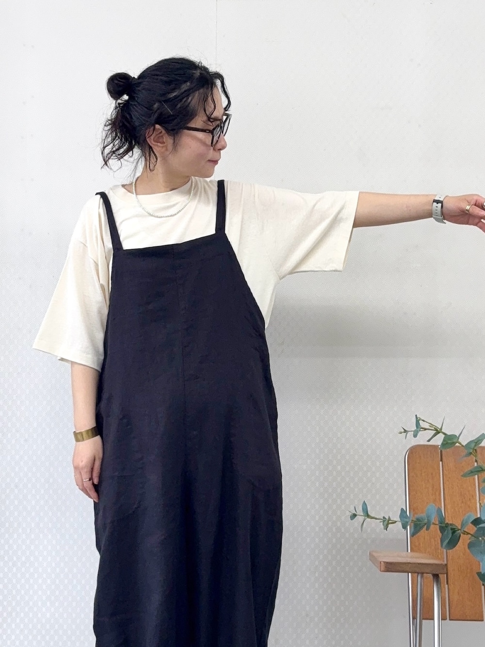 ブラウン系のサンダル、ブラック系のサロペット/オーバーオール、ベージュ系のTシャツ/カットソーを着用したレディースの春コーディネートの4枚目の写真