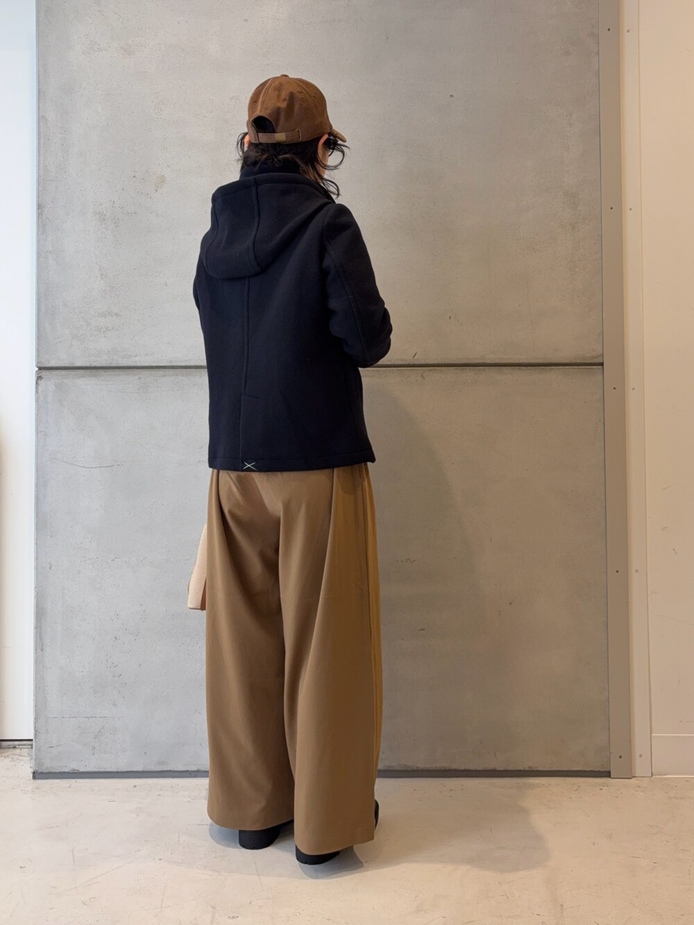 ブラウン系のブーツ、ホワイト系のニット/セーター、イエロー系のその他パンツを着用したレディースの冬コーディネートの5枚目の写真