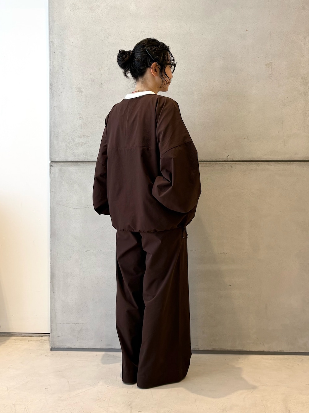 ブラウン系のカーディガン/ボレロ、ブラウン系のその他パンツ、ホワイト系のスニーカーを着用したレディースの春コーディネートの4枚目の写真