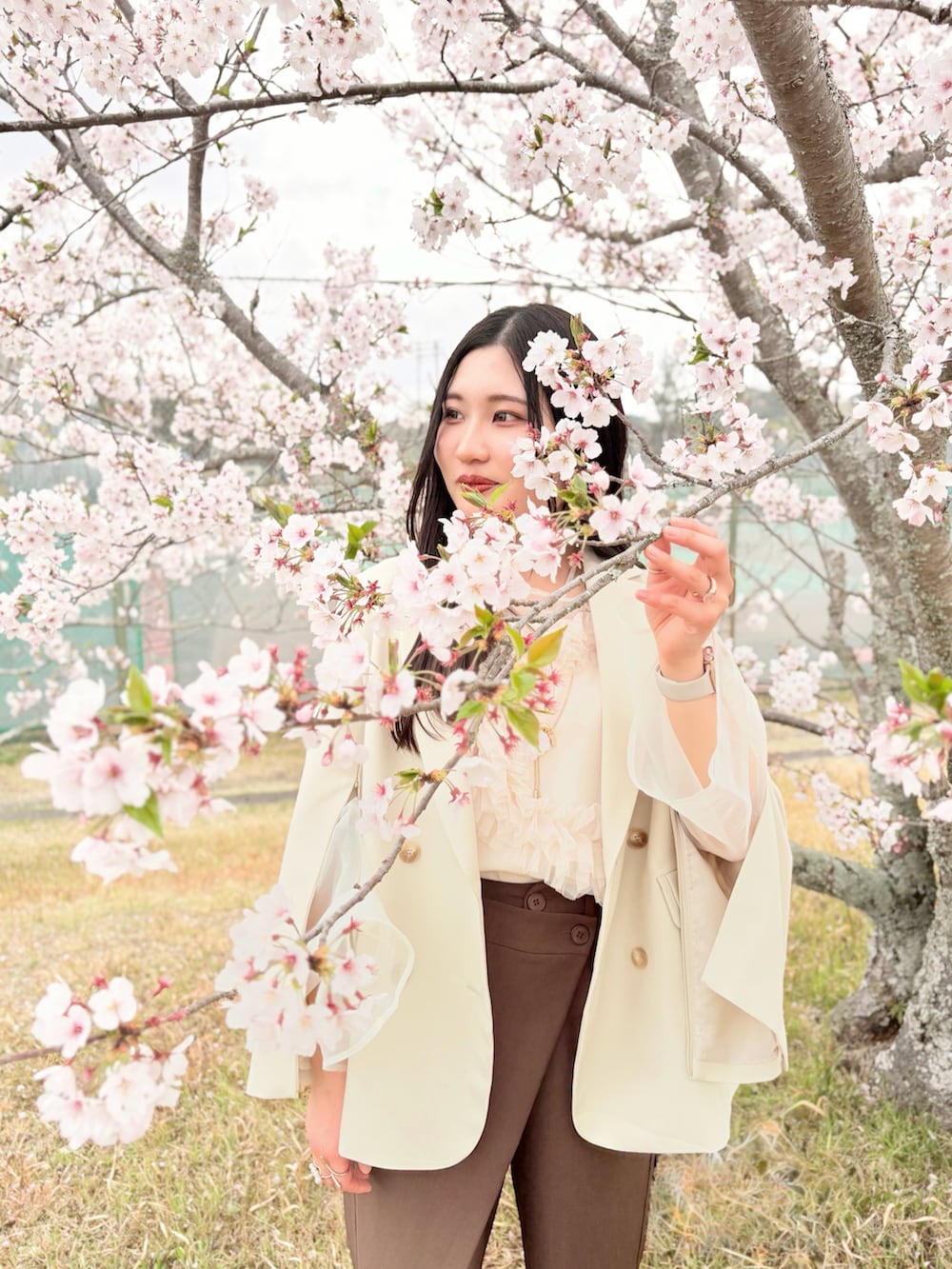 ベージュ系のテーラードジャケット、ベージュ系のシャツ/ブラウス、ブラウン系のパンツを着用したレディースの春コーディネートの3枚目の写真