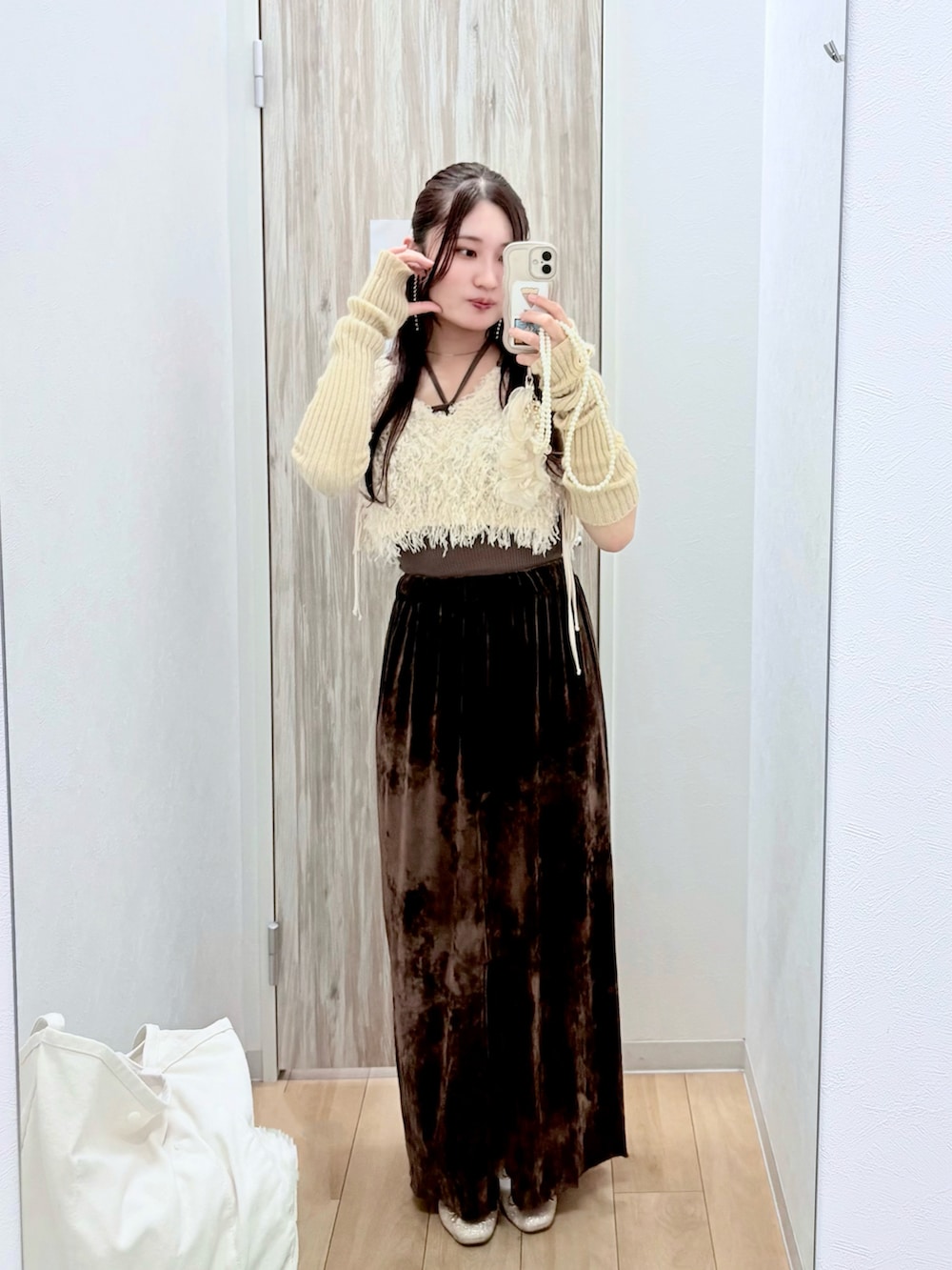 ベージュ系のワンピース、ブラウン系のスカート、ゴールド系のバレエシューズを着用したレディースの秋コーディネートの2枚目の写真