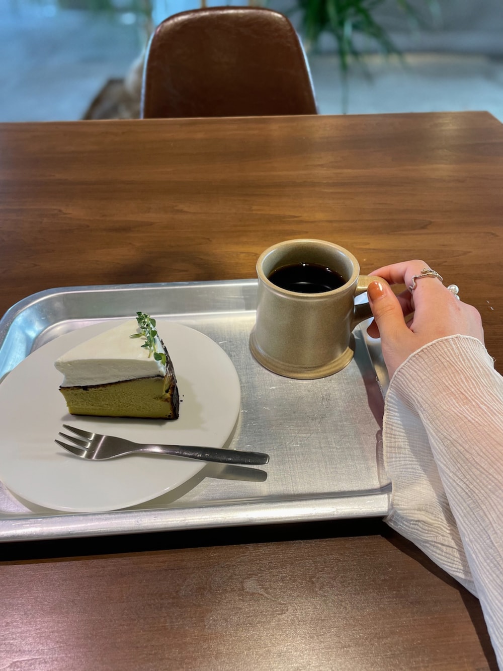 ホワイト系のシャツ/ブラウス、ホワイト系のスカート、ベージュ系のタンクトップを着用したレディースの春コーディネートの5枚目の写真