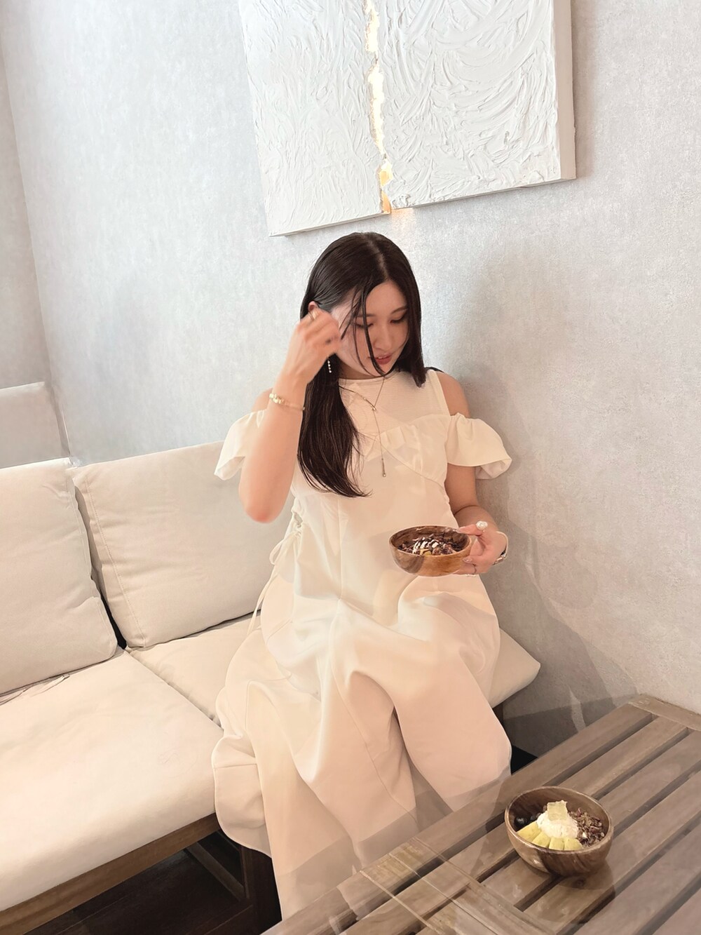 ホワイト系のワンピース、ホワイト系のトートバッグ、ゴールド系のネックレスを着用したレディースの夏コーディネートの3枚目の写真