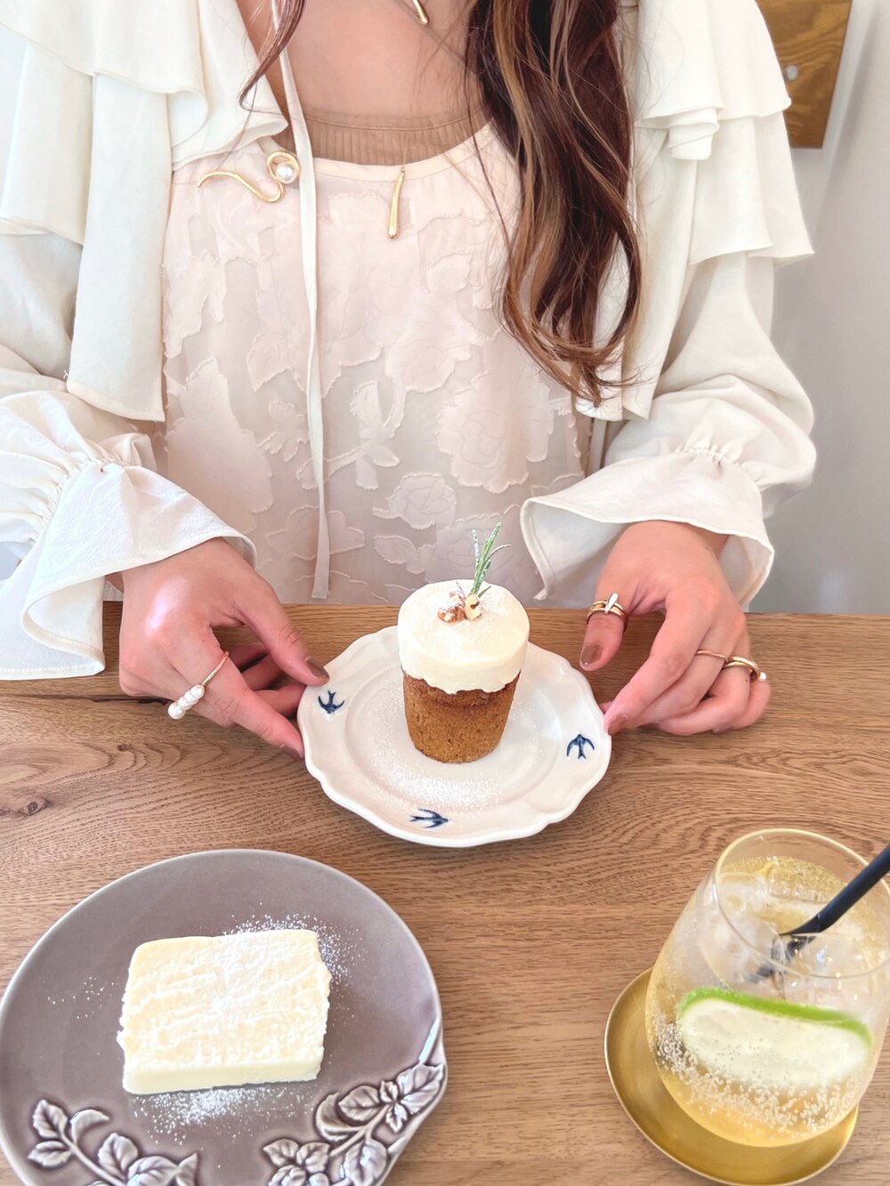 ホワイト系のカーディガン/ボレロ、ベージュ系のワンピース、ゴールド系のネックレスを着用したレディースの秋コーディネートの3枚目の写真