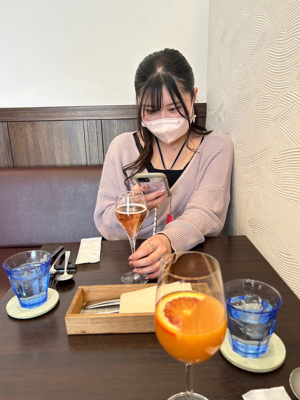 ピンク系のニット/セーター、ブラック系のスカート、ブラック系のキャミソールを着用したレディースの春コーディネートの3枚目の写真