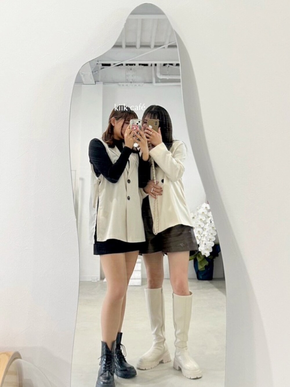 ホワイト系のセットアップ、ブラウン系のTシャツ/カットソー、ホワイト系のブーツを着用したレディースの秋コーディネートの2枚目の写真