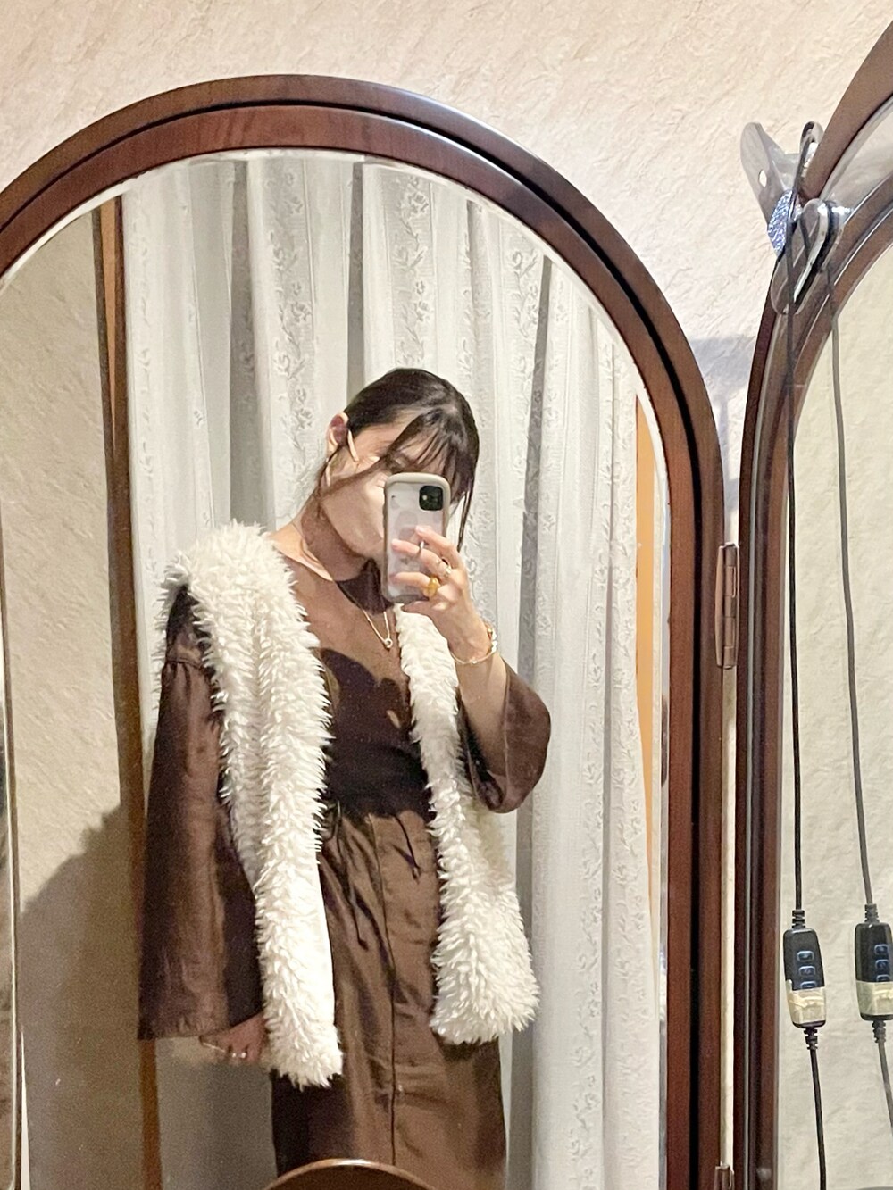 ブラウン系のワンピース、ホワイト系のベスト、ブラック系のキャミソールを着用したレディースの秋コーディネートの4枚目の写真