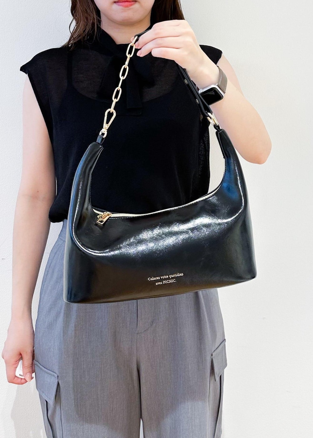 ブラック系のショルダーバッグ、グレー系のカーゴパンツ、ブラック系のニット/セーターを着用したレディースの夏コーディネートの6枚目の写真