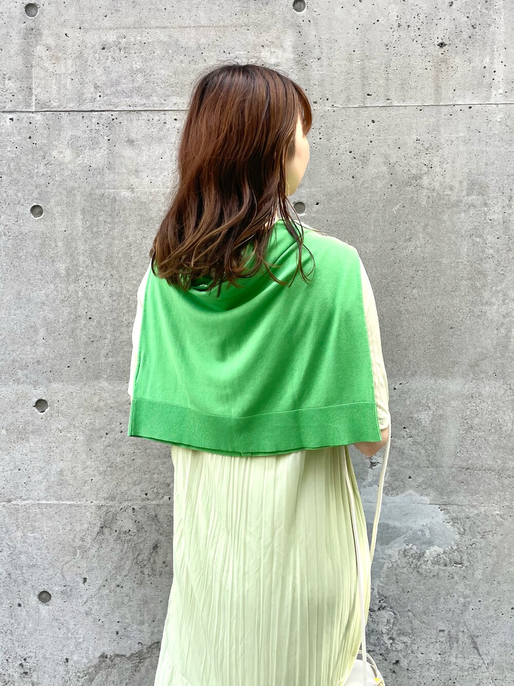 ホワイト系のサンダル、ホワイト系のドラムバッグ、グリーン系のカーディガン/ボレロを着用したレディースの夏コーディネートの4枚目の写真