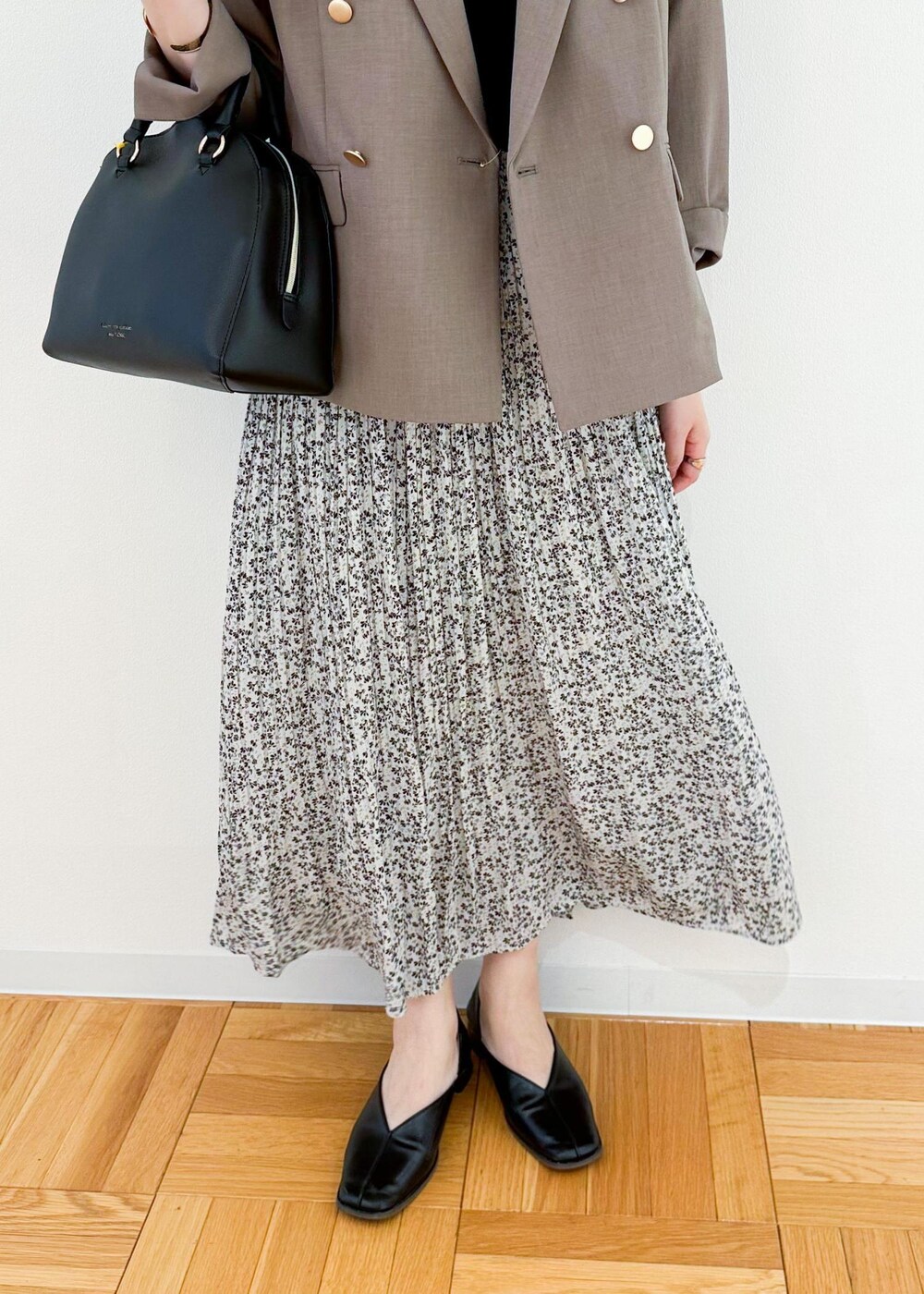 ベージュ系のスカート、ホワイト系のボストンバッグ、ブラウン系のテーラードジャケットを着用したレディースの夏コーディネートの6枚目の写真