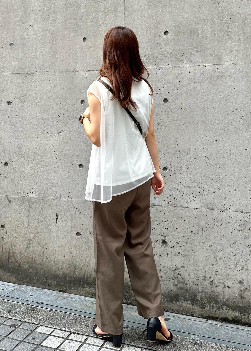 ブラック系のショルダーバッグ、ブラウン系のその他パンツ、ホワイト系のTシャツ/カットソーを着用したレディースの夏コーディネートの3枚目の写真