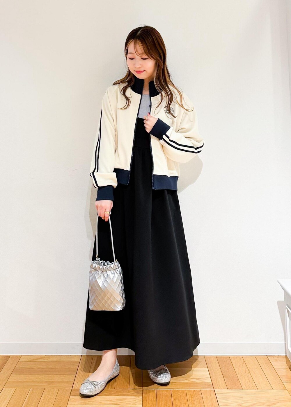 ブラック系のワンピース、グレー系のニット/セーター、シルバー系のショルダーバッグを着用したレディースの冬コーディネートの2枚目の写真