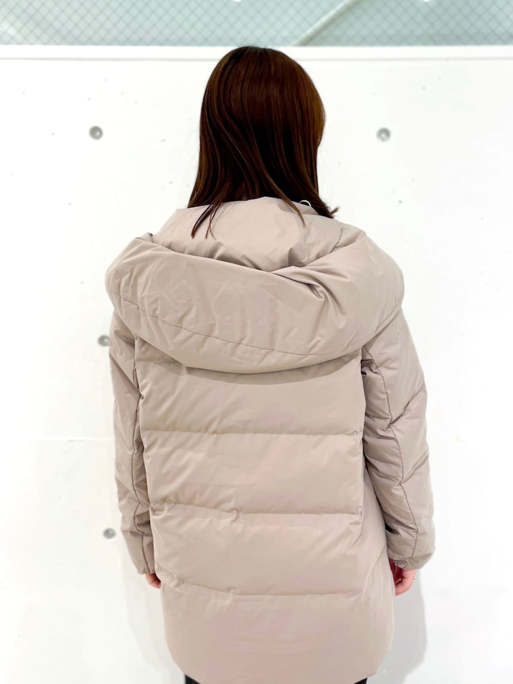 ブラウン系のダウンジャケット/コート、ブラック系のつなぎ/オールインワン、ブラウン系のニット/セーターを着用したレディースの冬コーディネートの4枚目の写真