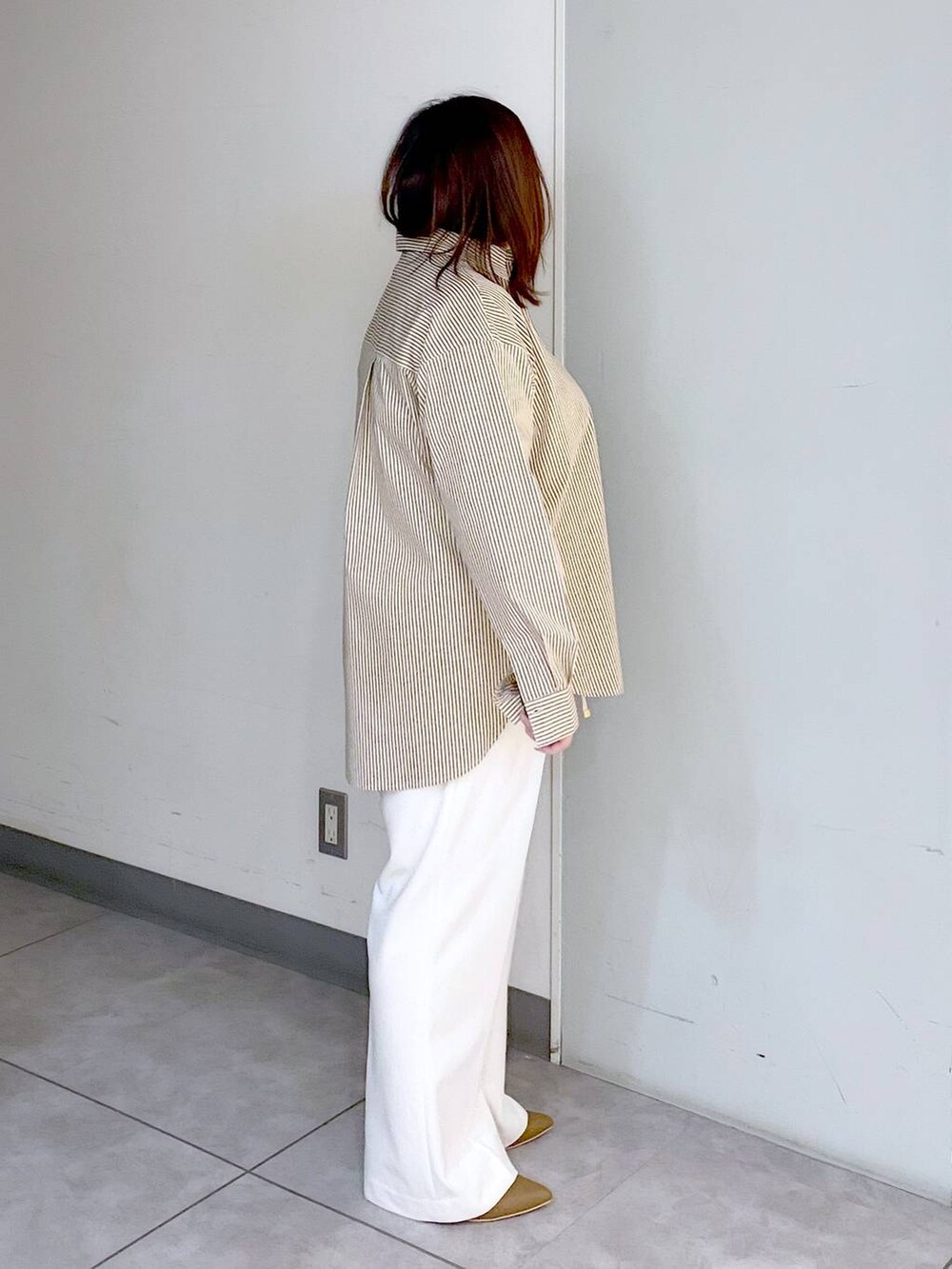 ブラウン系のパンプス、ベージュ系のニット/セーター、ホワイト系のその他パンツを着用したレディースの冬コーディネートの7枚目の写真