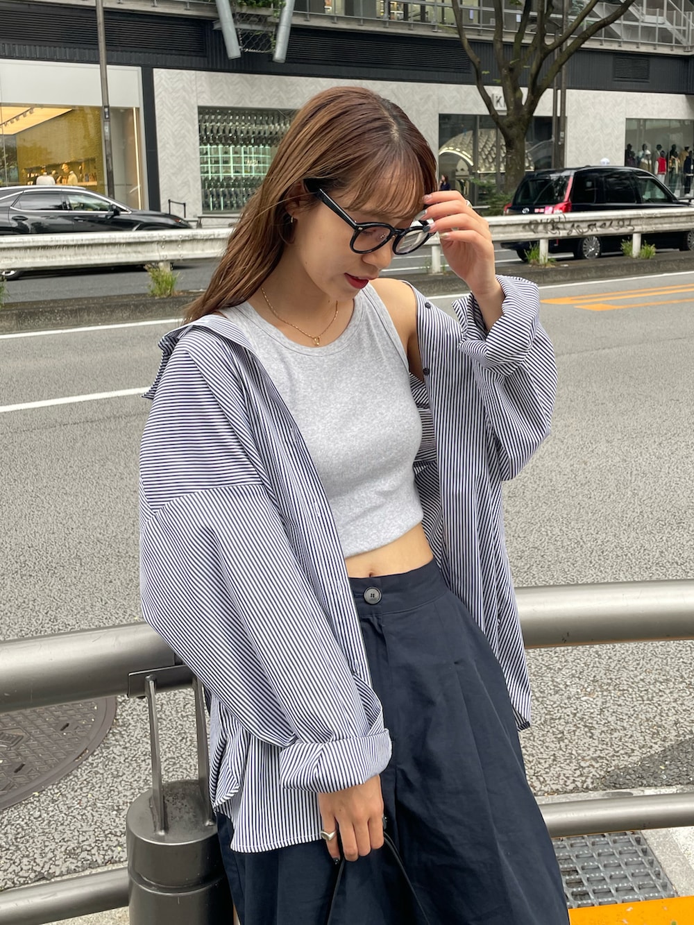 ブラック系のショルダーバッグ、ブルー系のその他パンツ、ホワイト系のスニーカーを着用したレディースの秋コーディネートの2枚目の写真