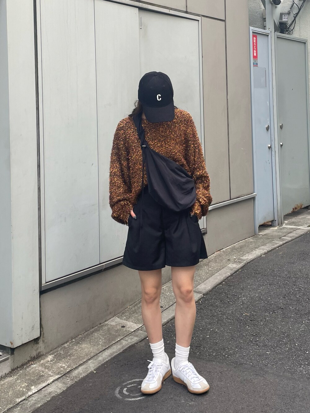 ブラウン系のニット/セーター、ホワイト系のスニーカー、ブラック系のその他パンツを着用したレディースの秋コーディネートの3枚目の写真