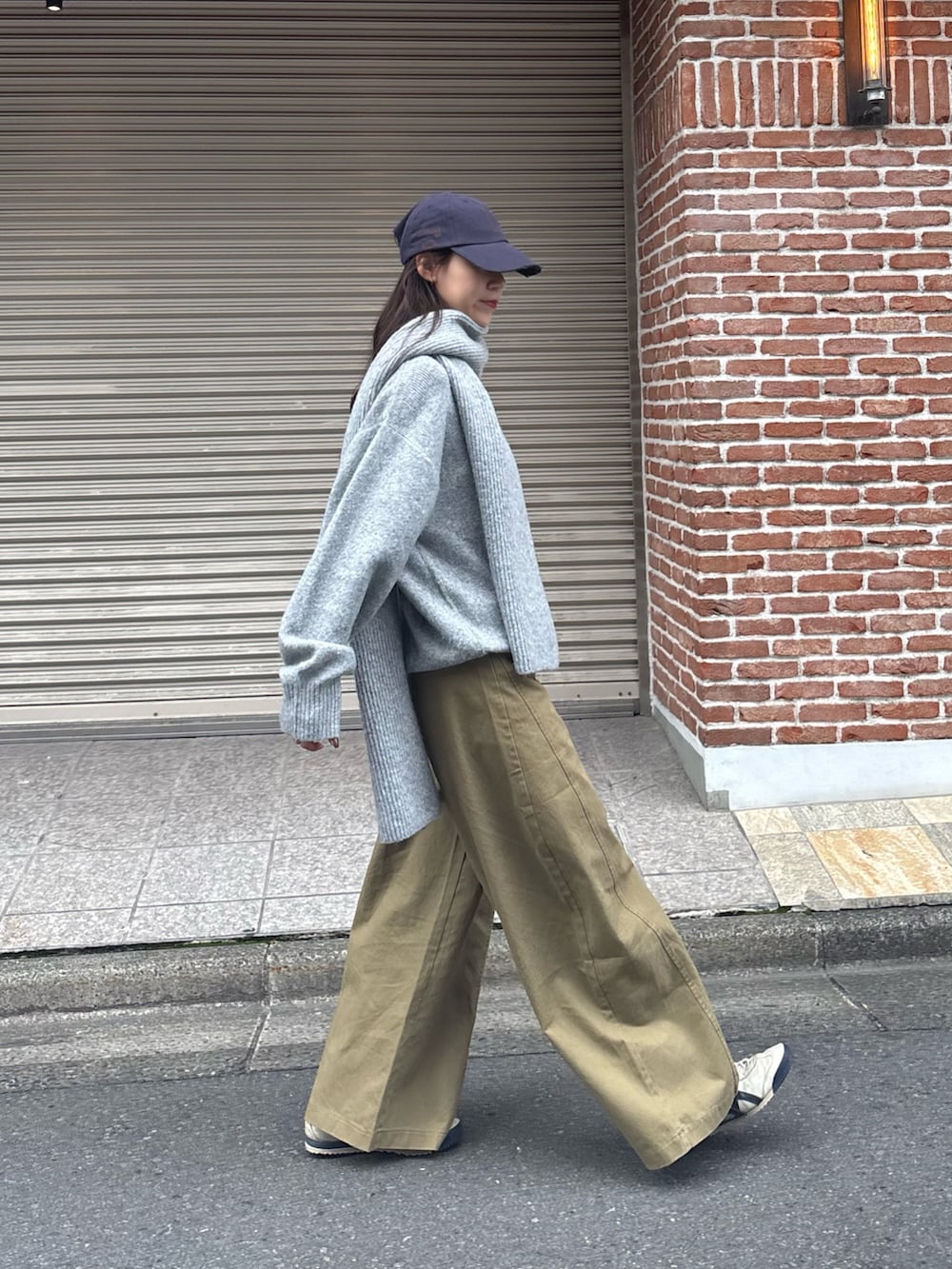 グレー系のニット/セーター、ブラウン系のショルダーバッグを着用したレディースの冬コーディネートの3枚目の写真