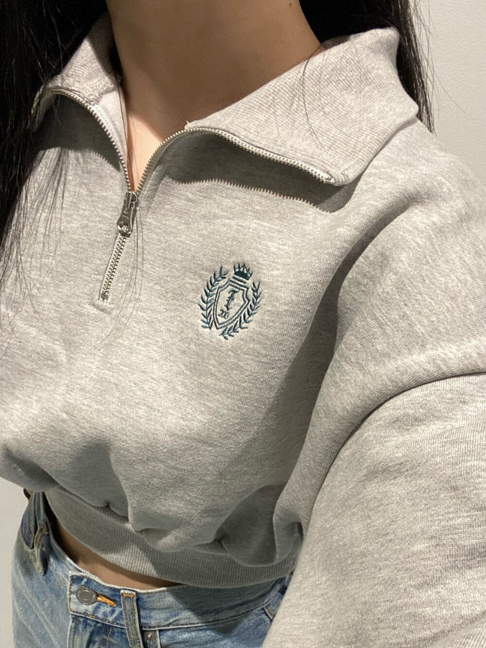 ブラック系のブルゾン、ブラック系のブーツ、ブルー系のデニムパンツを着用したレディースの秋コーディネートの5枚目の写真