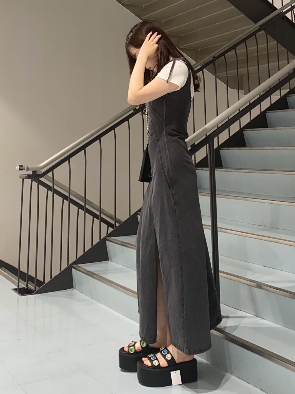 ブラック系のサンダル、ブラック系のワンピース、ホワイト系のTシャツ/カットソーを着用したレディースの夏コーディネートの2枚目の写真